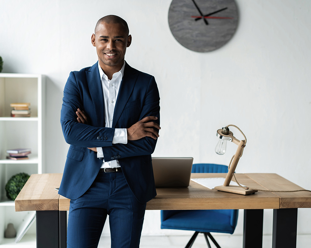 african american man leaning on office desk